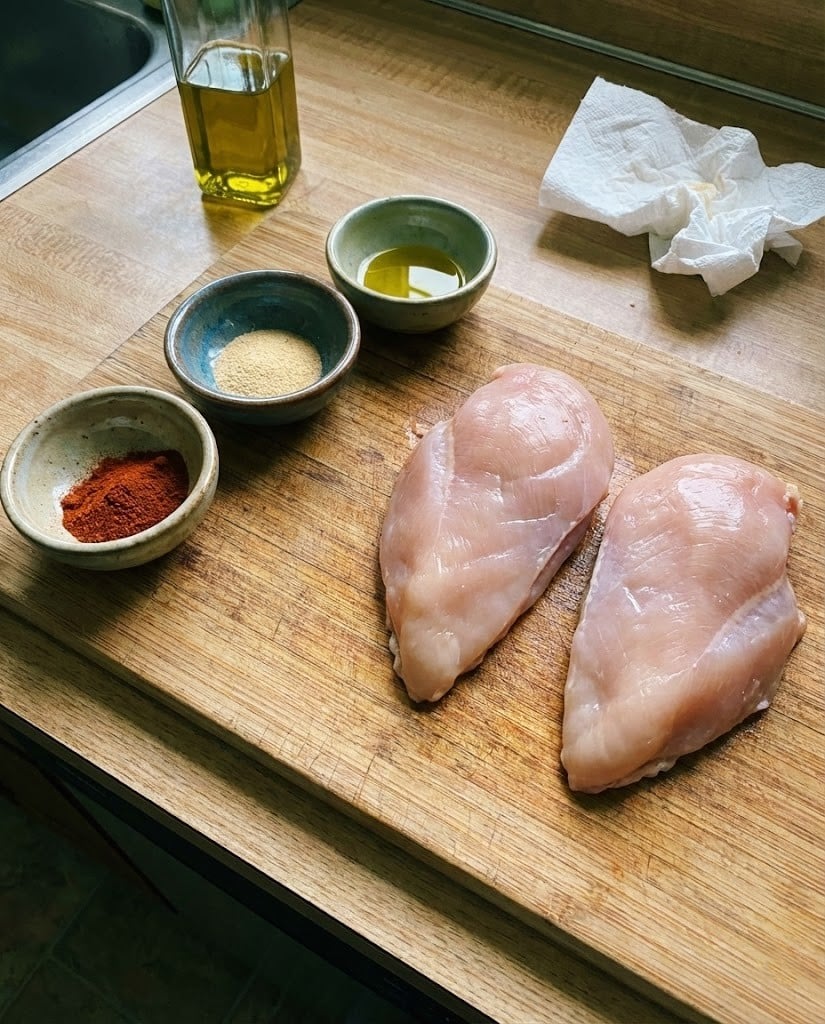 Easy Keto Air Fryer Chicken Breast (Juicy & No Breading) 6 Raw chicken breasts and keto spices ready for the air fryer.