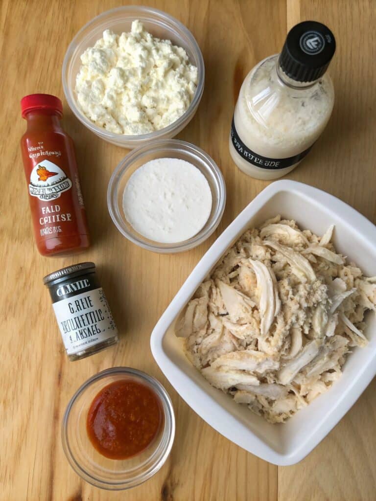 Ingredients for buffalo chicken dip on table