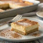 churro cheesecake bars in rustic tray