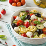 Tortellini pasta salad in a bowl with fresh vegetables