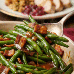 Serving spoonful of savory-sweet glazed green beans with crispy bacon.